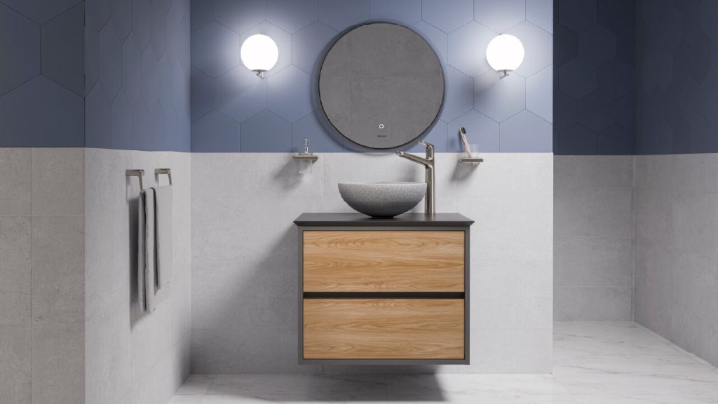 Baño Corona con paredes hexagonales y grises a medio muro y lavamanos tipo mármol.