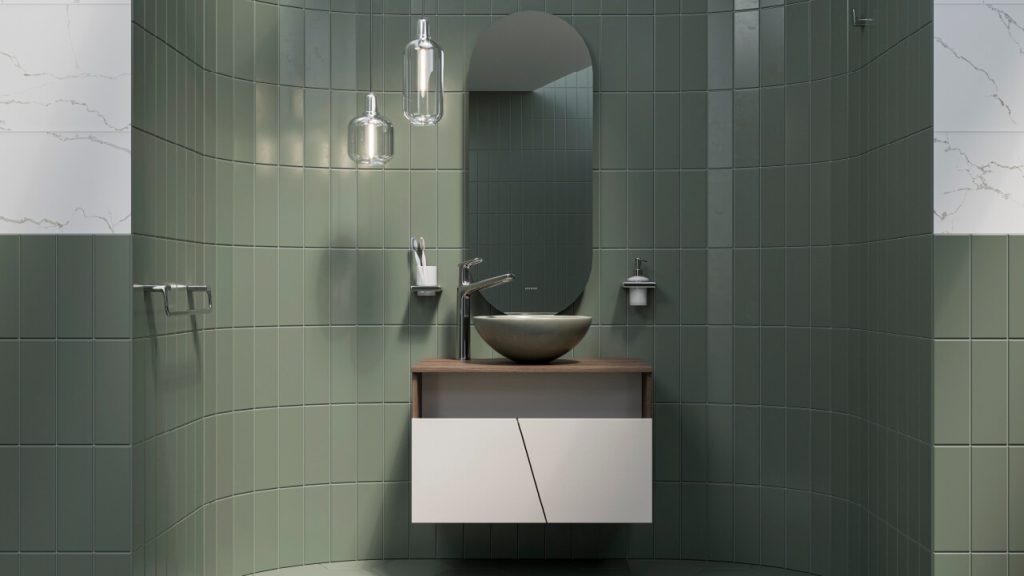 Baño Corona con baldosas pequeñas y lavamanos verde.